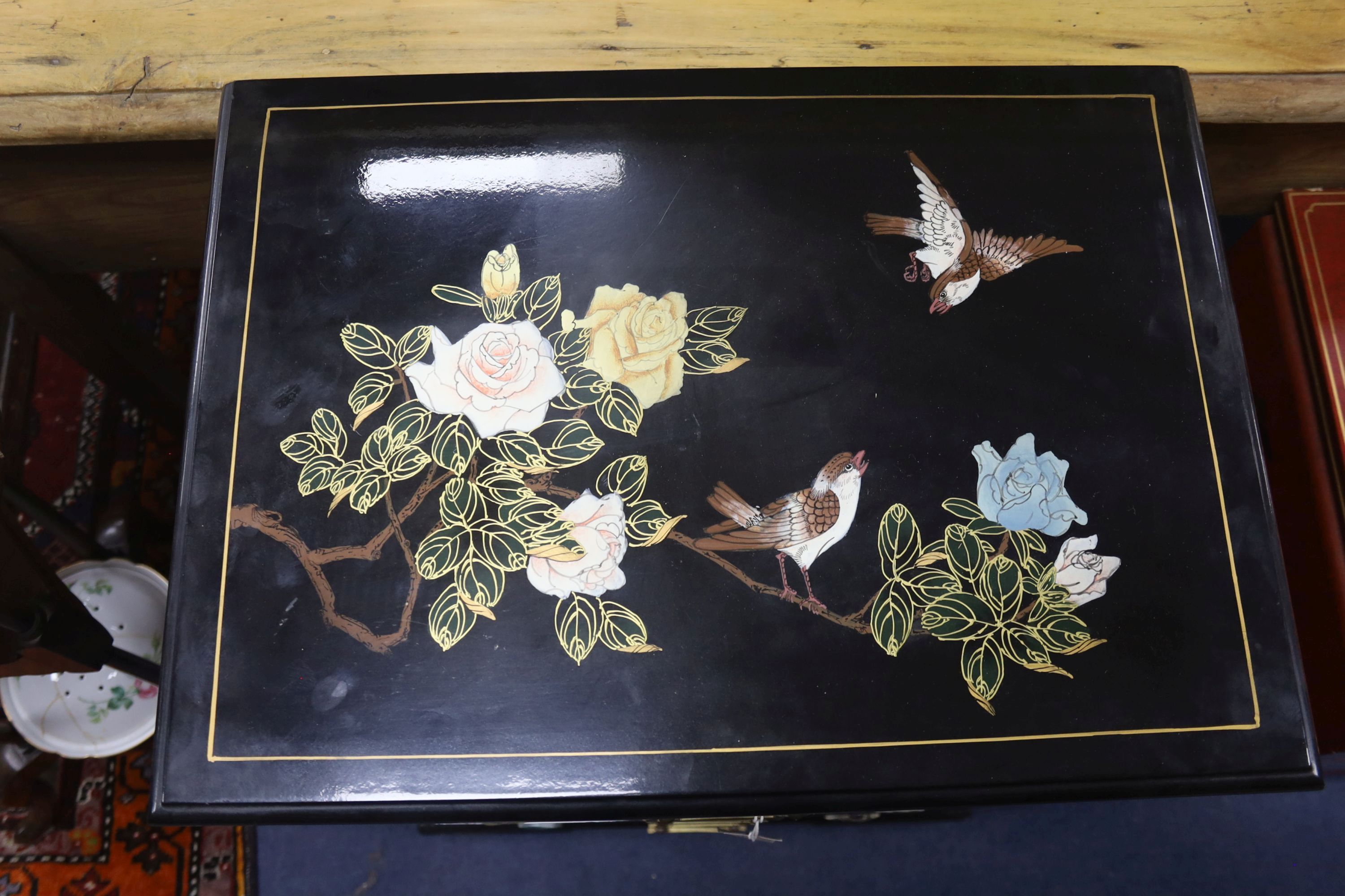 A Chinese black laquer chest of five drawers, a red lacquer chest and a cream lacquer coffee table